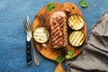 Grilled ribeye beef steak, herbs and spices on blue rustic background. Top view Royalty Free Stock Photo