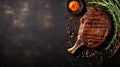 Grilled ribeye beef steak, herbs and spices, top view with copy space on dark table Royalty Free Stock Photo