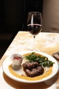 Grilled ribeye beef steak with red wine, herbs and spices on stone table Royalty Free Stock Photo