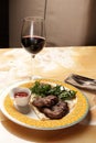 Grilled ribeye beef steak with red wine, herbs and spices on stone table Royalty Free Stock Photo