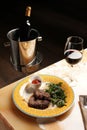 Grilled ribeye beef steak with red wine, herbs and spices on stone table Royalty Free Stock Photo
