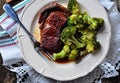 Grilled ribeye steak with boiled broccoli in olive oil and sea salt