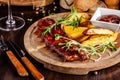 Grilled ribs with potatoes in a rustic style with barbecue sauce. Serving dishes in the restaurant on a wooden board