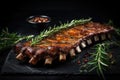 Grilled ribs with rosemary and spices on a black background, grilled ribs with herbs and spices on Black background, copy space,