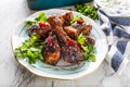 Grilled roasted and barbecue chicken legs on white plate. Royalty Free Stock Photo