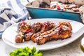 Grilled roasted and barbecue chicken legs on white plate. Royalty Free Stock Photo