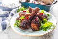 Grilled roasted and barbecue chicken legs on white plate. Royalty Free Stock Photo