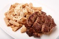 Grilled roasted Entrecote steak meat on a white plate with pasta and cheese isolated on white