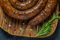 Grilled or Roasted spiral pork sausages with rosemary, salt and peper Royalty Free Stock Photo