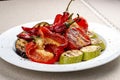Grilled roasted vegetables on a white plate.  Sweet peppers, tomatoes, zucchini, eggplant Royalty Free Stock Photo