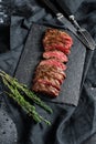 Grilled roasting rare sliced skirt, machete steak. Marble meat beef. Black background. Top view