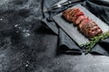 Grilled roasting rare sliced skirt, machete steak. Marble meat beef. Black background. Top view. Copy space