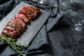 Grilled roasting rare sliced top blade, Denver steak. Marble meat beef. Black background. Top view. Copy space