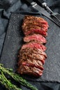 Grilled roasting rare sliced vegas strip steak. Marble meat beef. Black background. Top view