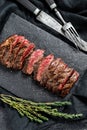 Grilled roasting rare sliced vegas strip steak. Marble meat beef. Black background. Top view