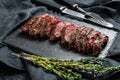 Grilled roasting rare sliced vegas strip steak. Marble meat beef. Black background. Top view