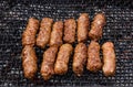 Grilled Romanian meat rolls on barbecue grid - mititei, mici