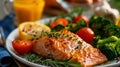 a grilled salmon and broccoli dinner with white wine on a black plate Royalty Free Stock Photo