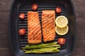 Grilled salmon cooked BBQ on a pan on wooden background Royalty Free Stock Photo