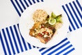 Grilled salmon, couscous - buckwheat risotto and striped napkin Royalty Free Stock Photo