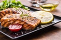 Grilled salmon fillet with salad tomatoes and sesame Royalty Free Stock Photo