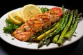Grilled salmon fillet with steamed asparagus and fresh lemon - healthy seafood recipe
