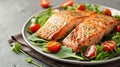 Grilled salmon fillets on a bed of arugula and cherry tomatoes on a plate.