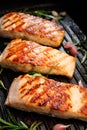 Grilled salmon fillets with fresh herbs and garlic on a grill plate Royalty Free Stock Photo