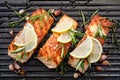 Grilled salmon fillets sprinkled with fresh herbs and lemon juice on a grill plate Royalty Free Stock Photo