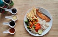 Grilled salmon fish and baked cod fish decorated with various vegetables corn carrot peas lemon french fries and sauces Royalty Free Stock Photo