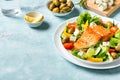 Grilled salmon fish fillet and greek salad Royalty Free Stock Photo