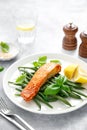 Grilled salmon fish fillet and green beans with lemon and basil Royalty Free Stock Photo