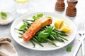 Grilled salmon fish fillet and green beans with lemon and basil Royalty Free Stock Photo