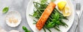 Grilled salmon fish fillet and green beans with lemon and basil. Banner Royalty Free Stock Photo