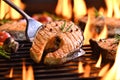 Grilled salmon fish on the flaming grill Royalty Free Stock Photo