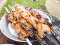 Grilled salmon fish kebab skewers on wooden board. Dark wooden background Royalty Free Stock Photo