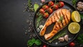 Grilled salmon fish with seasoning and various vegetables on black stone background Royalty Free Stock Photo