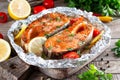 Grilled salmon fish with seasoning and various vegetables on table Royalty Free Stock Photo