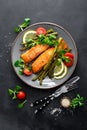 Grilled salmon fish steak, asparagus, tomato and corn salad on plate. Healthy dish for lunch Royalty Free Stock Photo