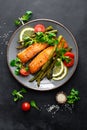 Grilled salmon fish steak, asparagus, tomato and corn salad on plate. Healthy dish for lunch Royalty Free Stock Photo