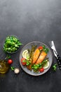 Grilled salmon fish steak, asparagus, tomato and corn salad on plate. Healthy dish for lunch