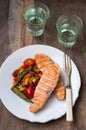 Grilled Salmon Steak with Sauteed Vegetables on White Plate