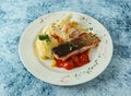 grilled salmon fish with tomato and mashed potato served in plate isolated on background top view of italian food Royalty Free Stock Photo