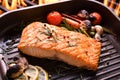 Grilled salmon fish with various vegetables on pan Royalty Free Stock Photo