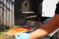 Grilled salmon on the flaming grill. Fresh raw salmon fillet on wooden board wrapped in foil cooking on grill.