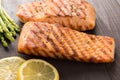 Grilled salmon with lemon, asparagus on the wooden table Royalty Free Stock Photo