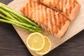 Grilled salmon and lemon, asparagus, on the wooden table Royalty Free Stock Photo