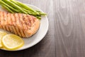 Grilled salmon and lemon, asparagus, on the wooden table Royalty Free Stock Photo