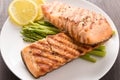 Grilled salmon and lemon, asparagus, on the wooden table Royalty Free Stock Photo