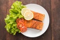 Grilled salmon with lemon,tomato on the wooden background Royalty Free Stock Photo